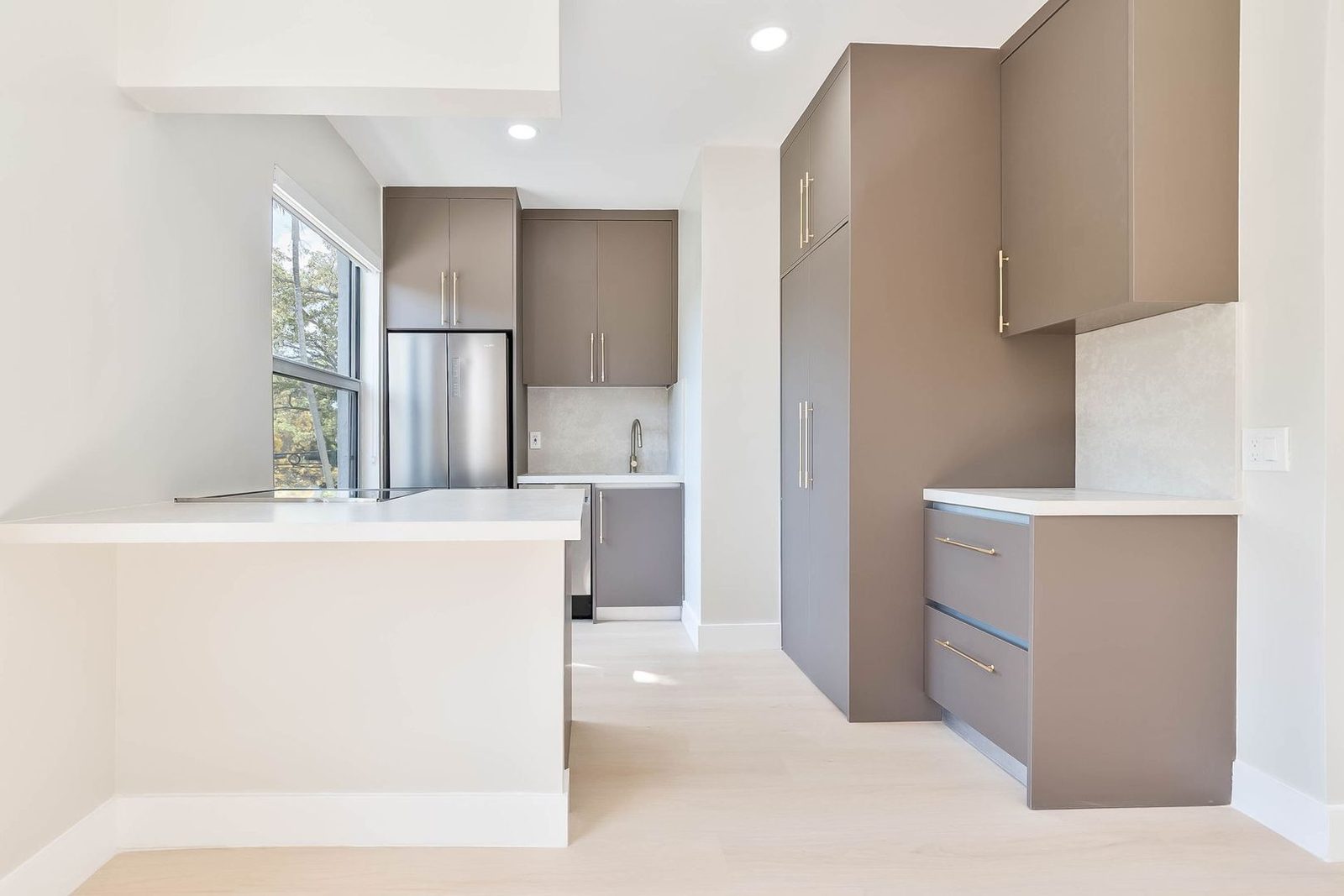 Kitchen island with quartz countertops and stainless appliances